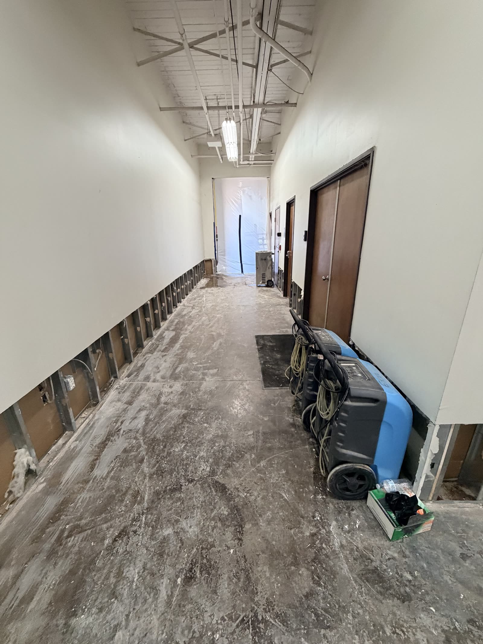 Fort Worth — wet drywall removed at the corridor base