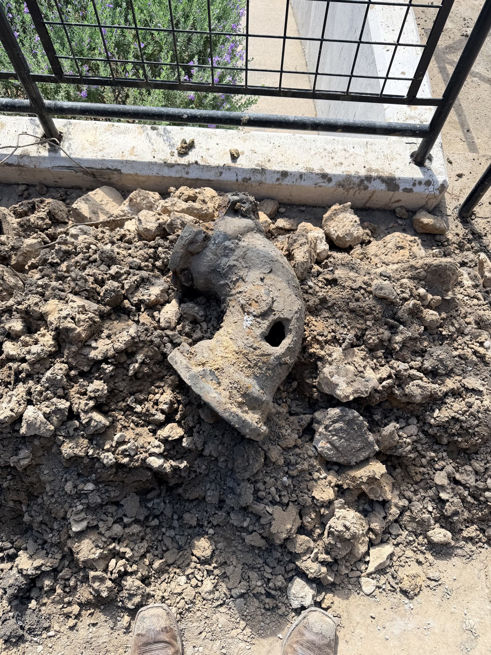 Fort Worth — failed cast-iron pipe fitting pulled from the excavation