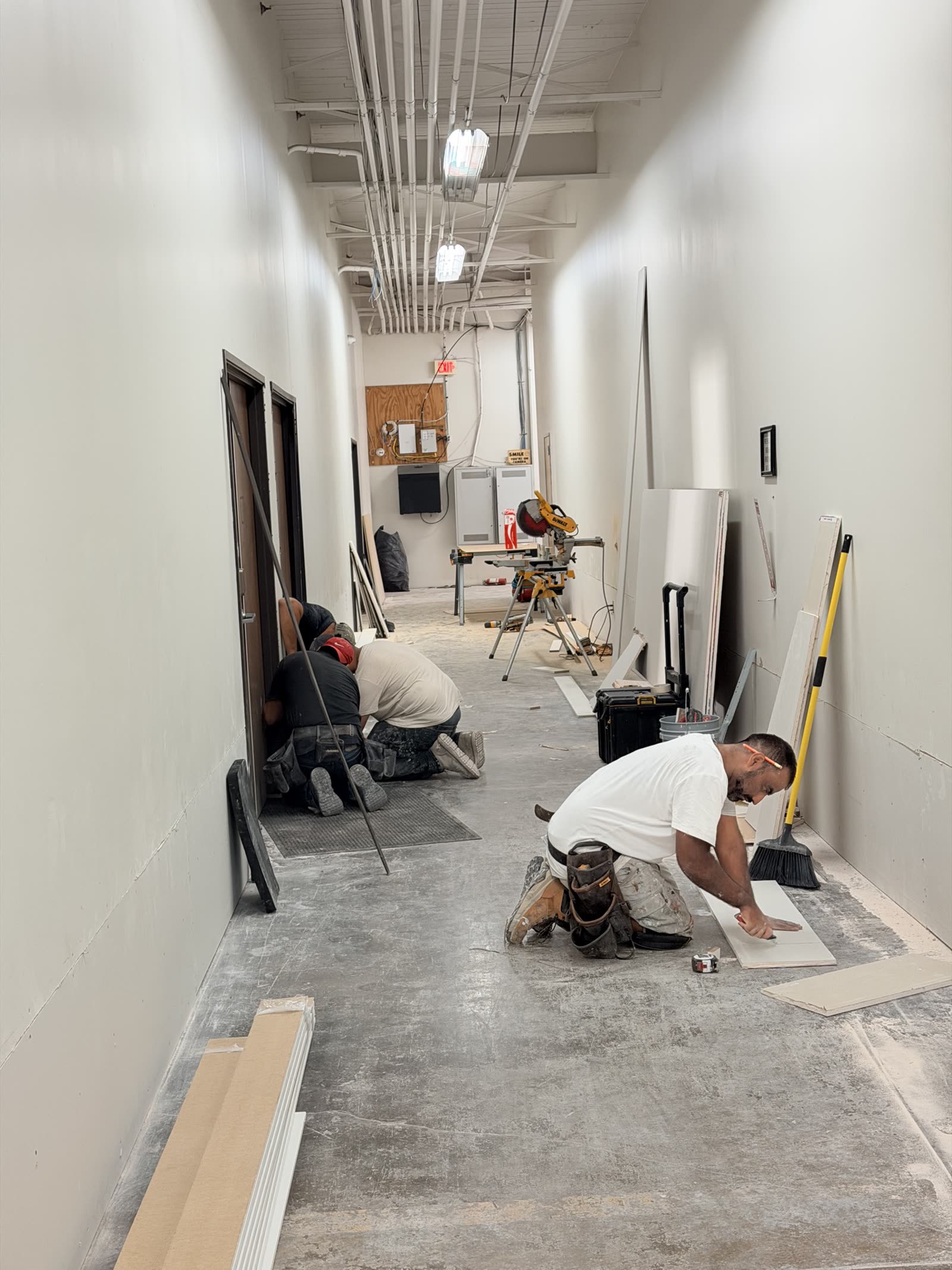 Fort Worth — installing base trim after the corridor walls went back