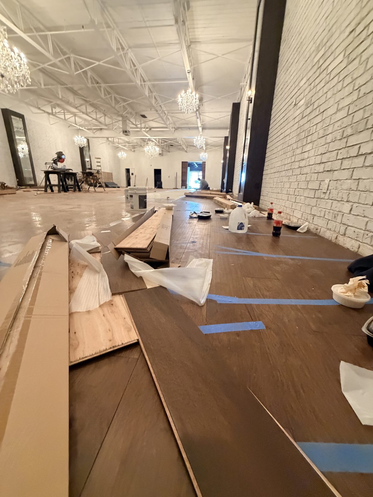 Dallas Design District — chandelier suite during the hardwood rebuild