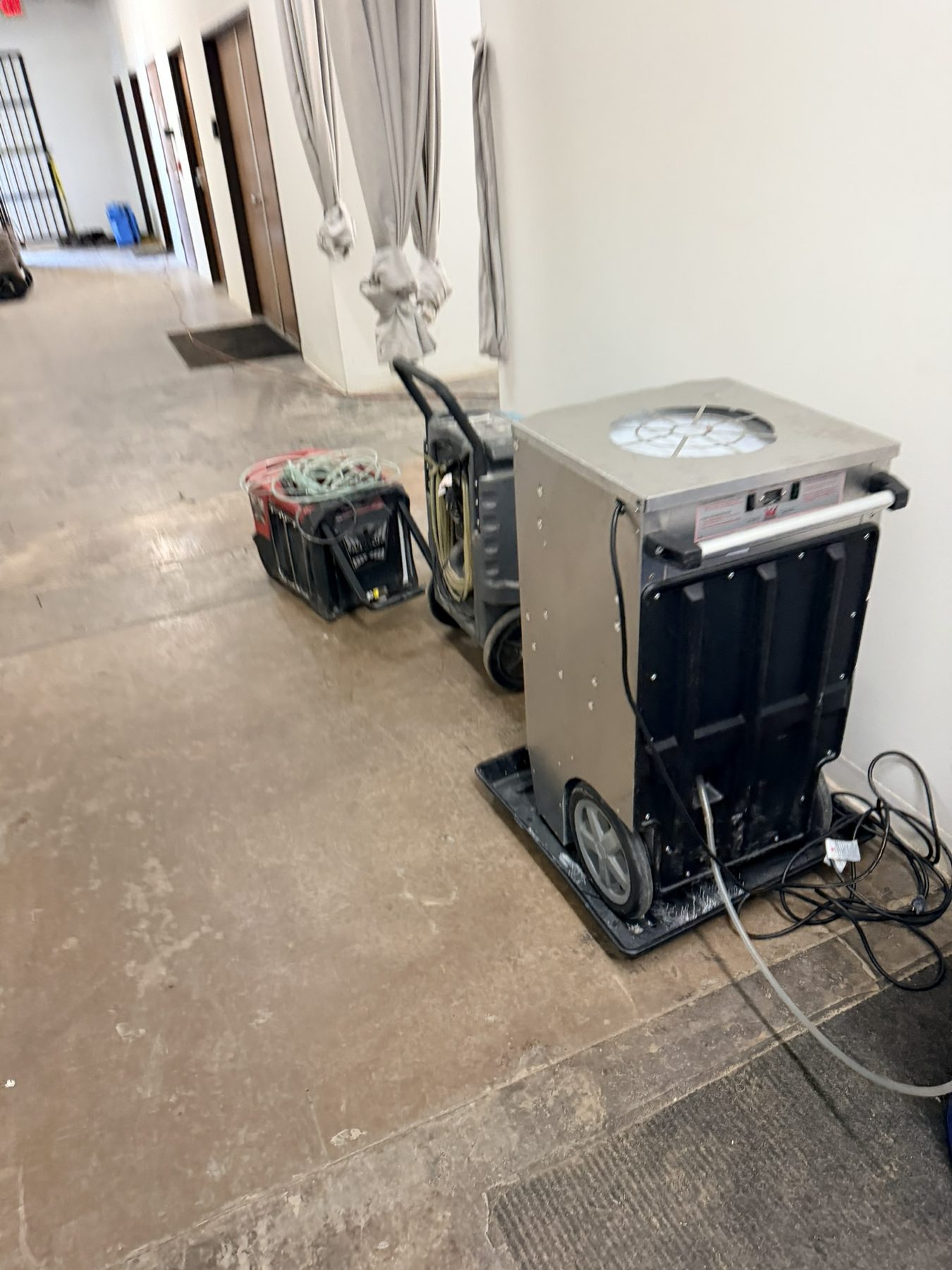 Dallas Design District — dehumidifier on the corridor drying path