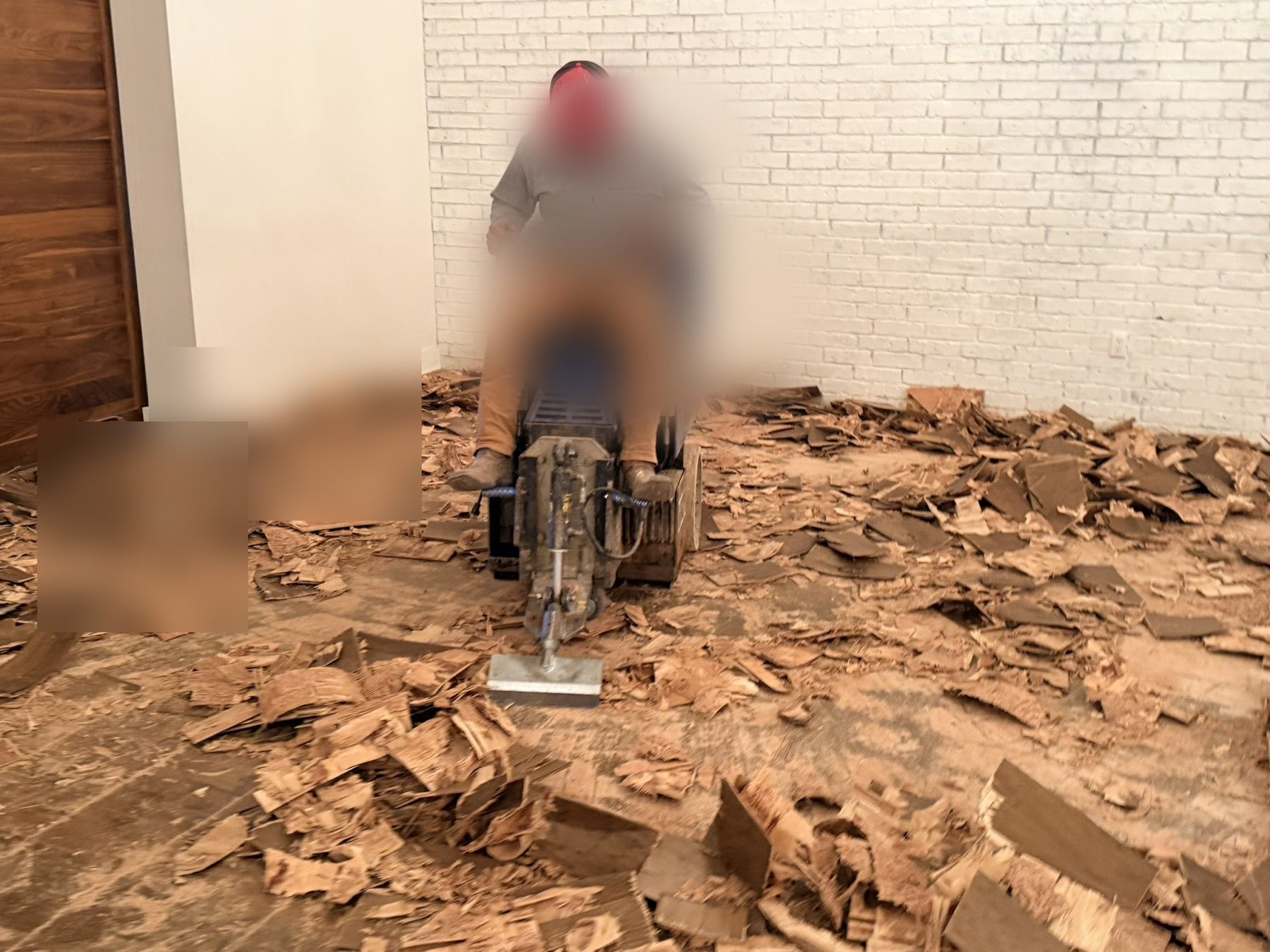 Dallas Design District — ride-on scraper pulling failed hardwood