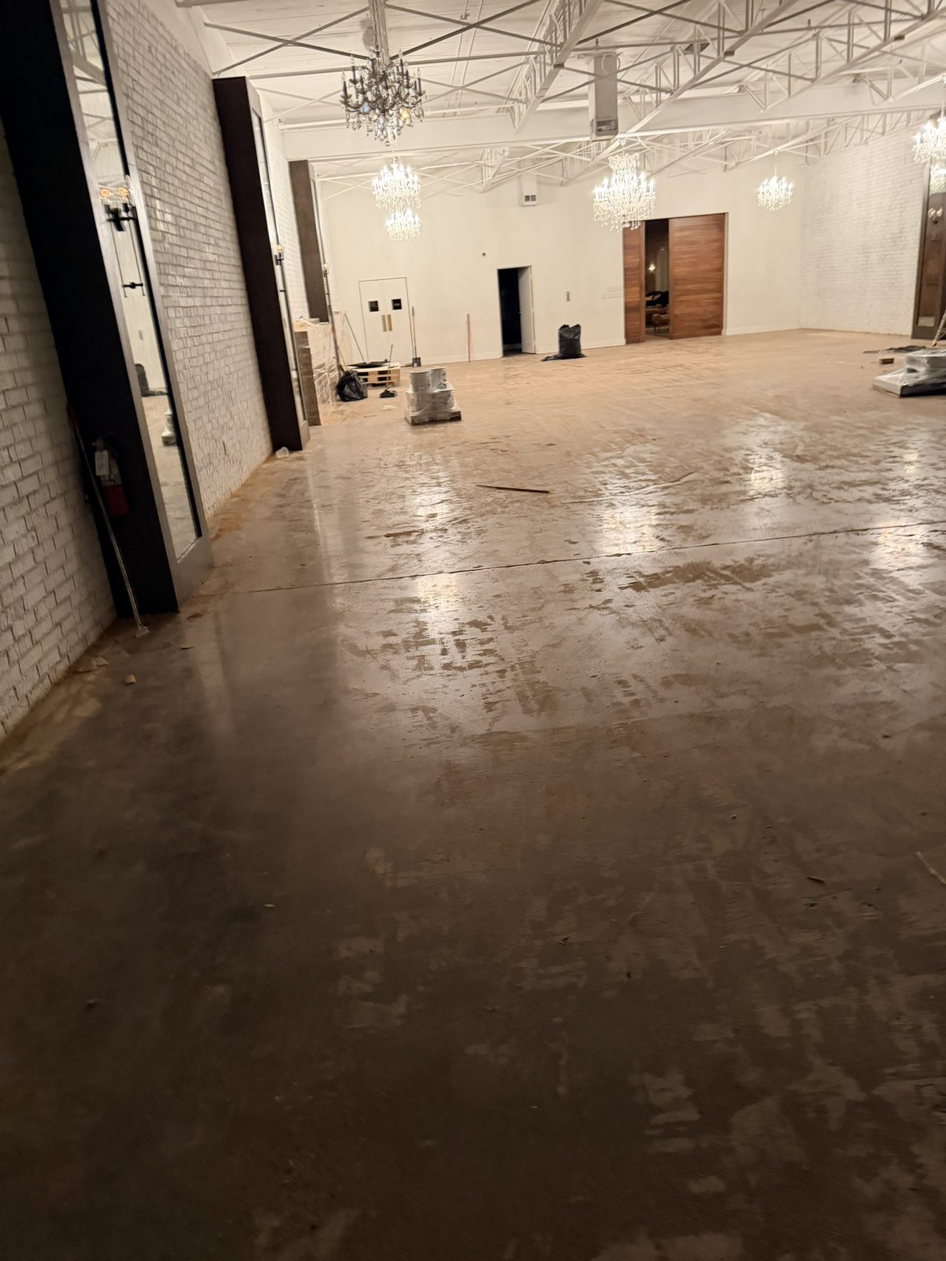 Dallas Design District — wet hardwood in the chandelier suite