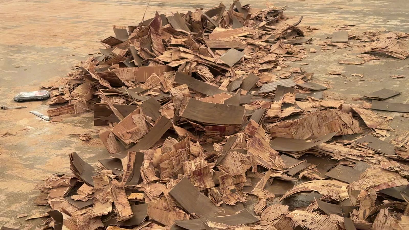 Dallas Design District — piles of failed hardwood on the slab