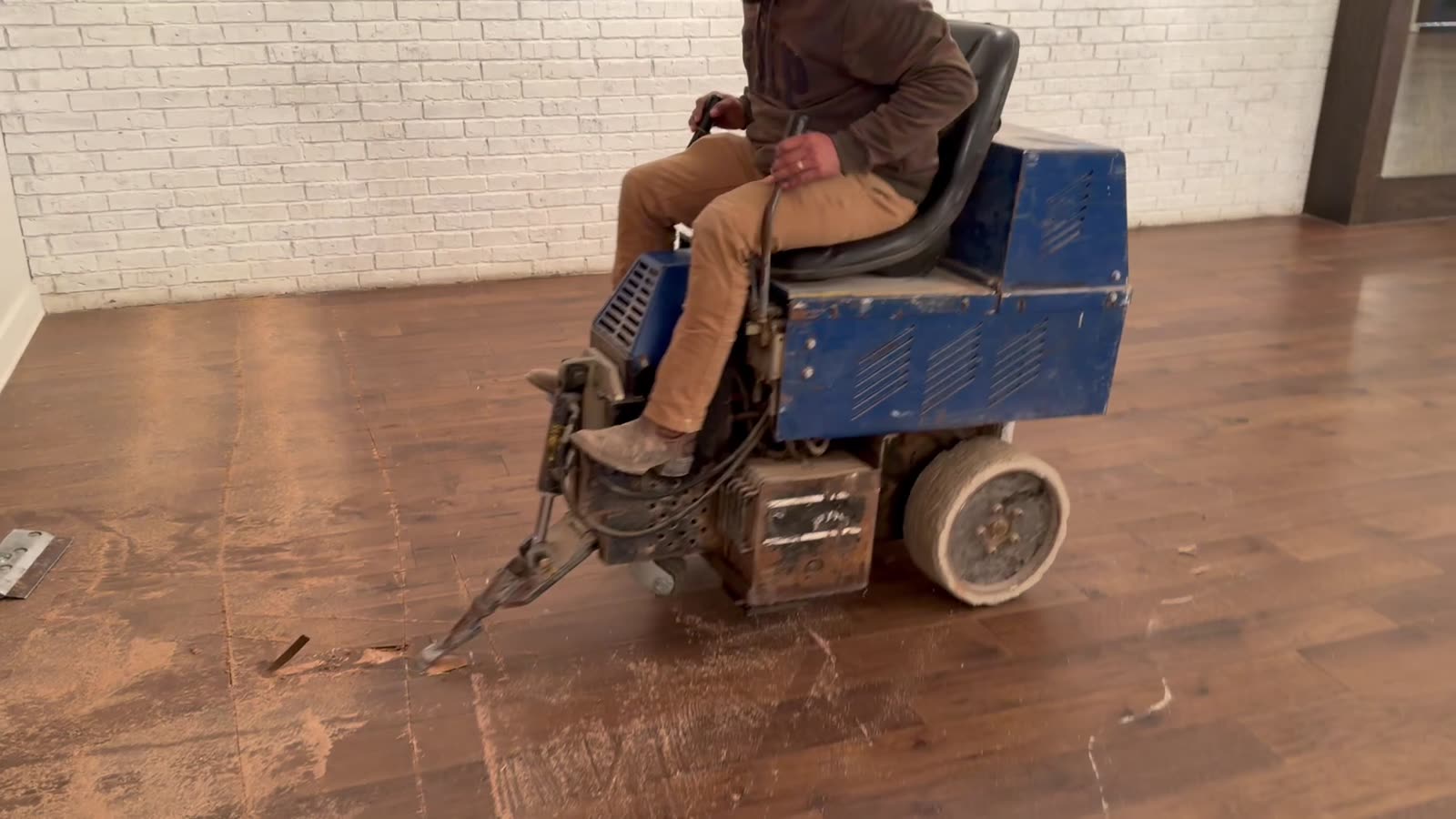 Dallas Design District — ride-on scraper on cupped hardwood